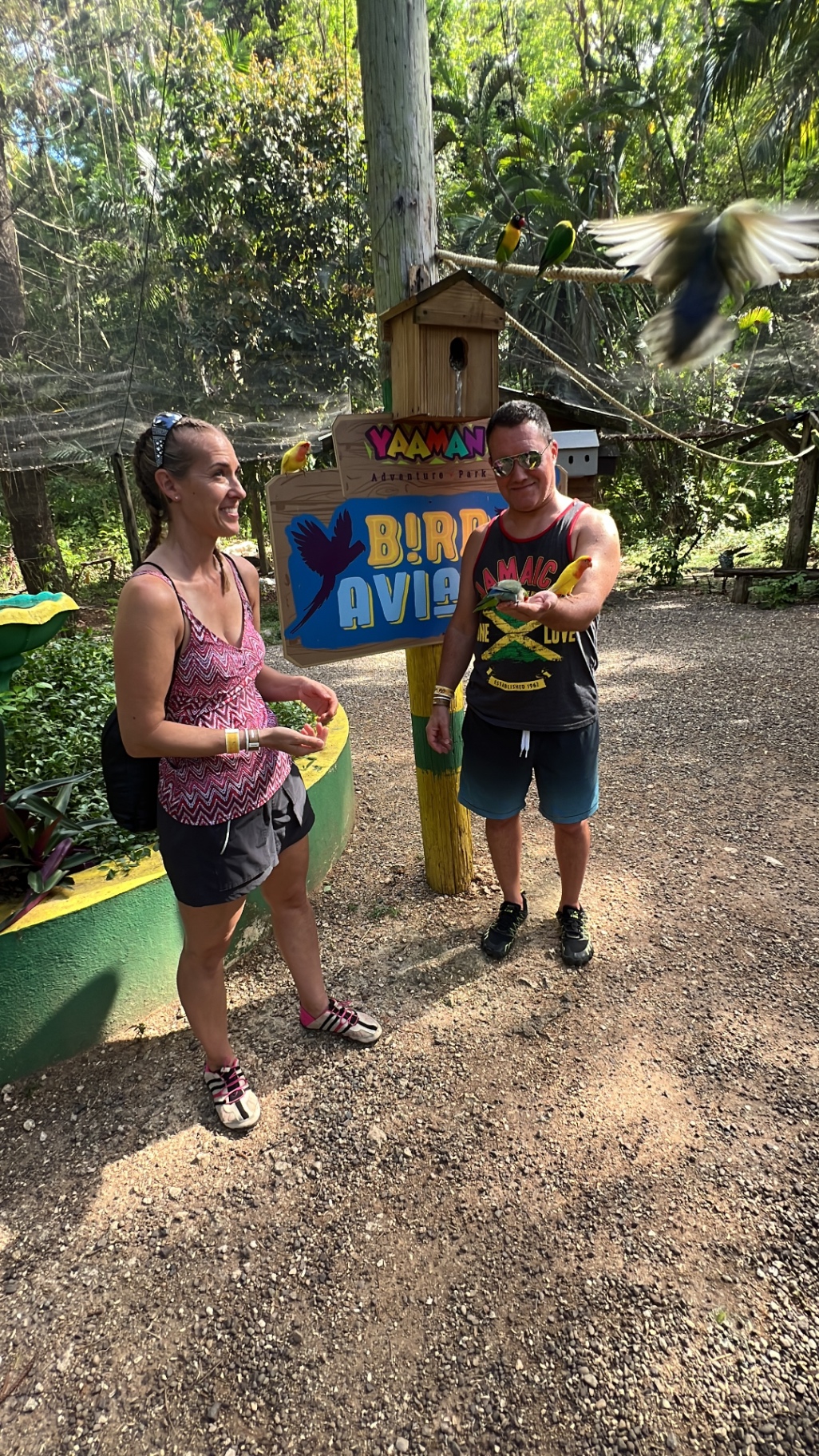 Adam and Jen Conway holding lovebirds at the Yaaman Adventure Park bird aviary