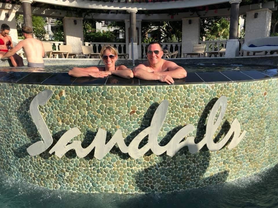 Jen and Adam Conway in a Sandals resort pool